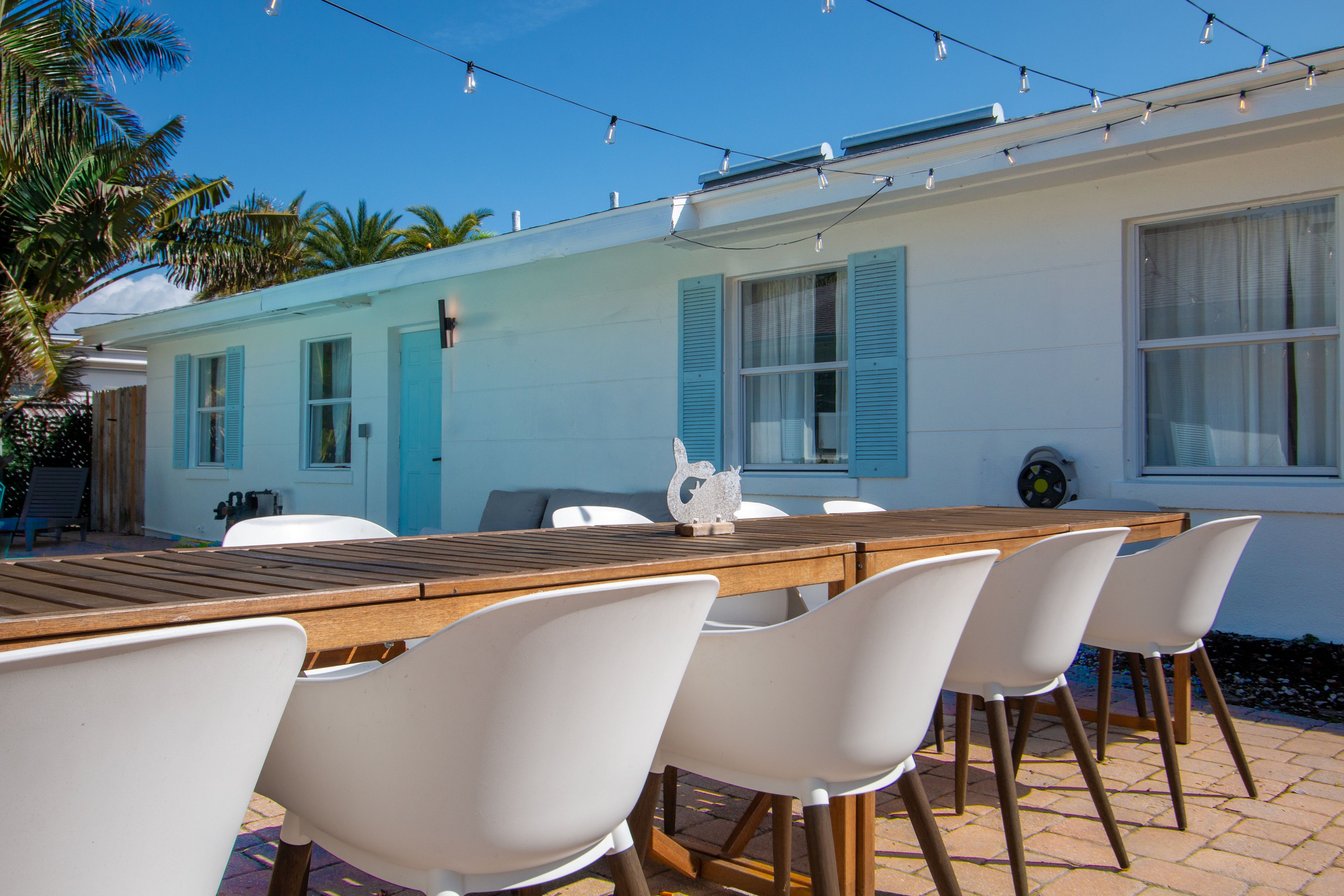 Outdoor dining area at Sea Glass Beach Compound featuring spacious patio seating, tropical coastal design, and luxury Clearwater Beach vacation rental accommodations for families and group gatherings