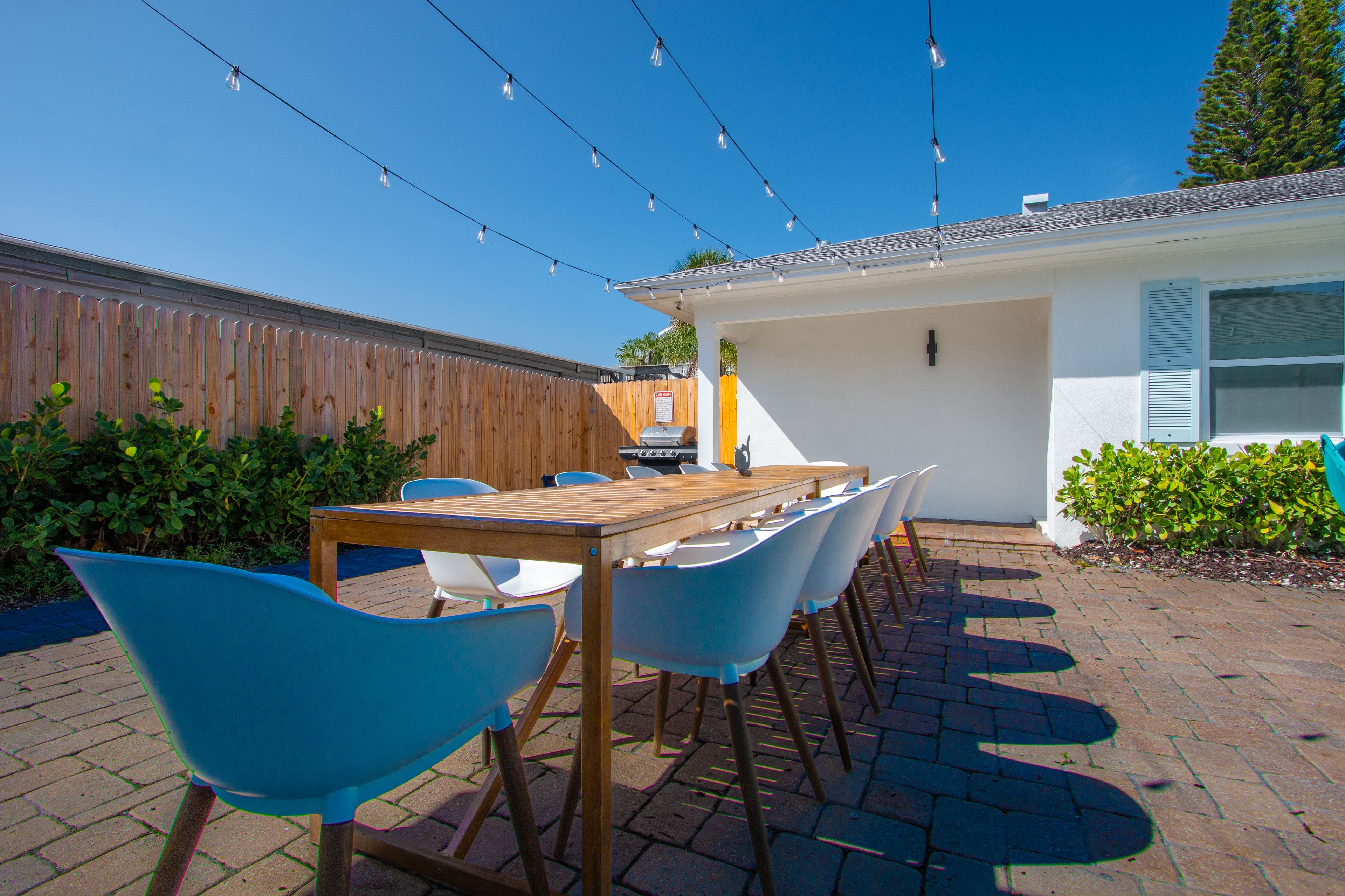 Spacious outdoor dining space at Sea Glass Beach Compound featuring patio seating for groups, coastal vacation rental design, and luxury Clearwater Beach accommodations near the Gulf Coast beaches